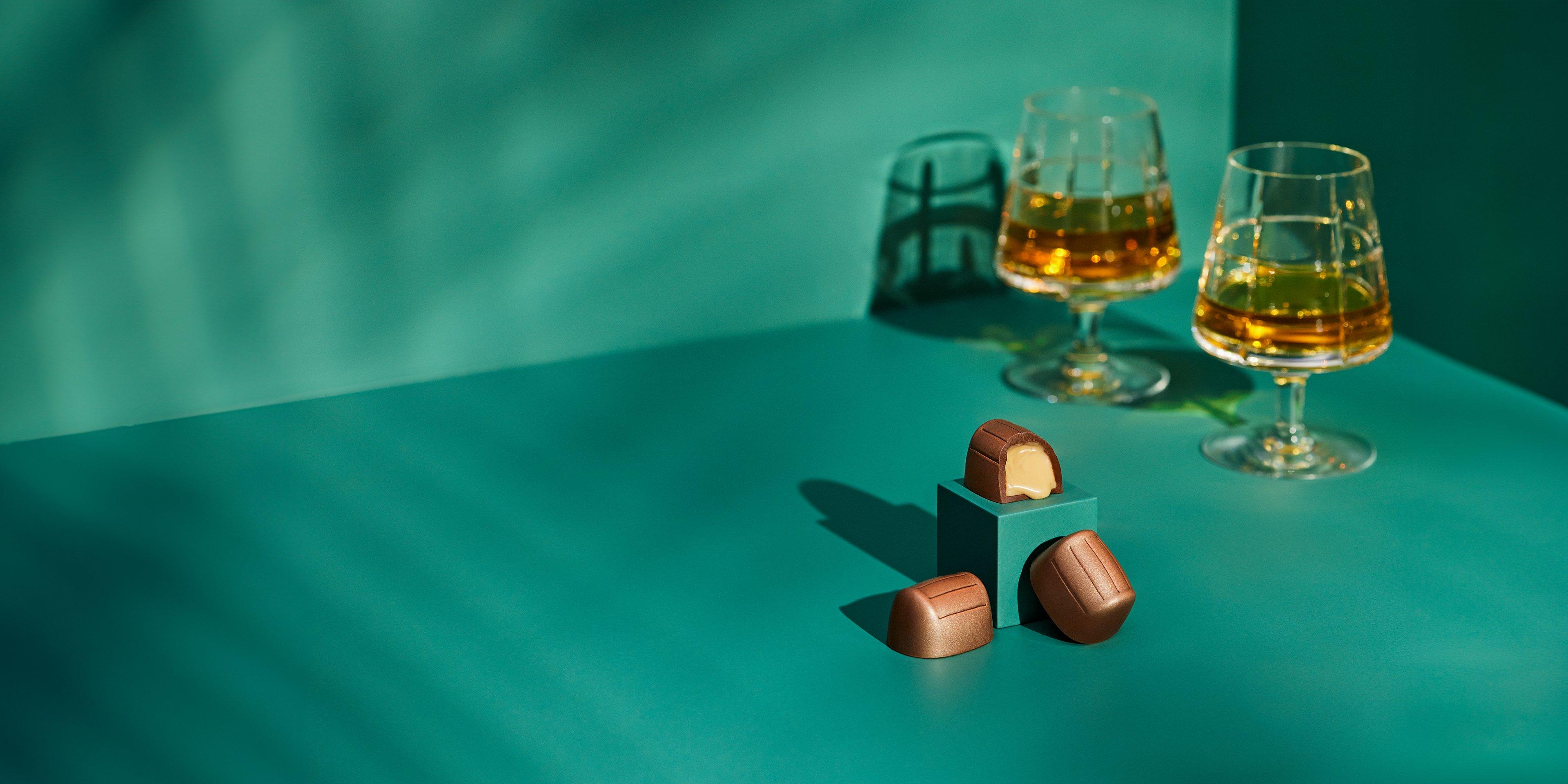 Glasses of whisky paired with rich handcrafted liqueur chocolates.